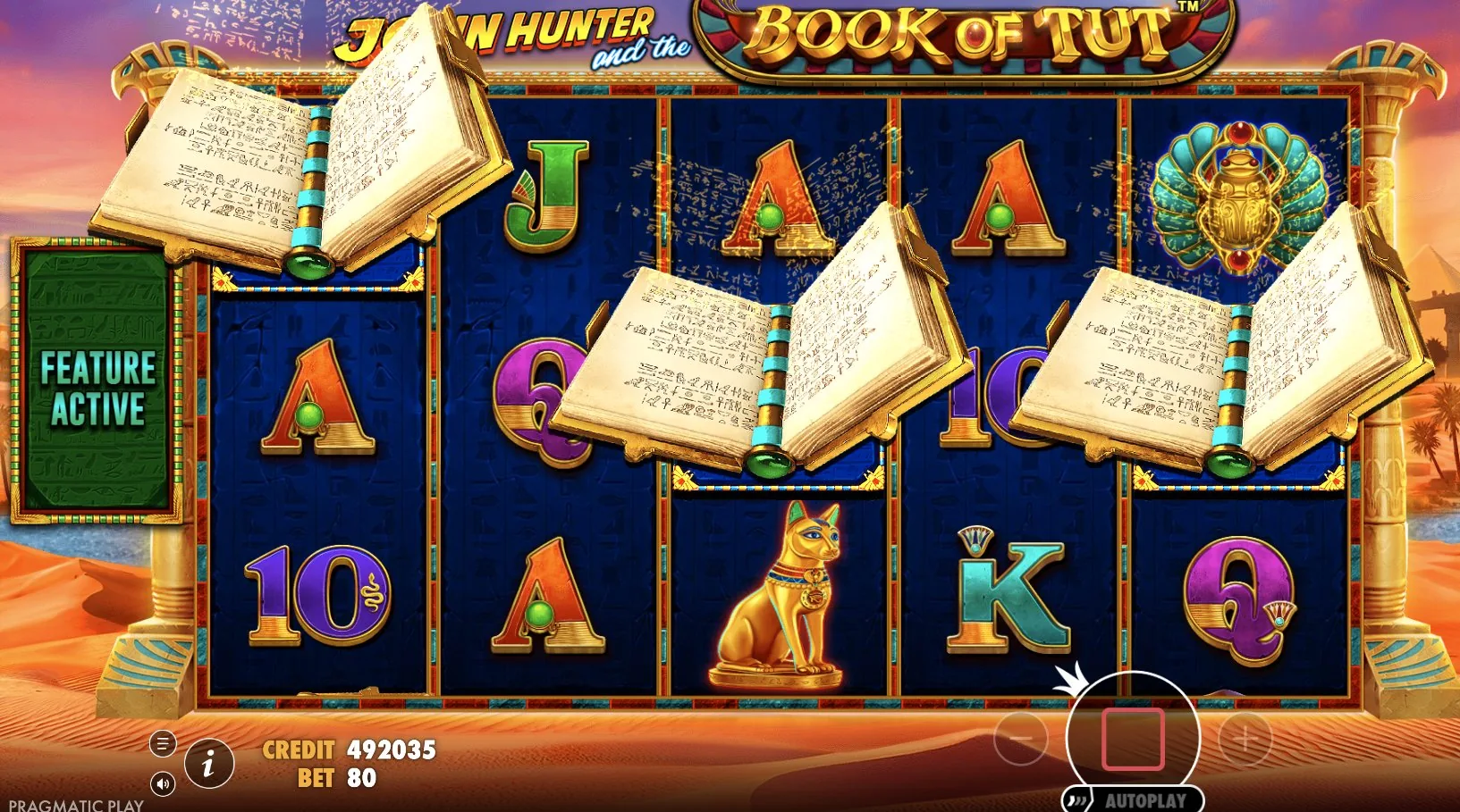 Aktive Bonusrunde von Book of Tut mit Büchern auf mehreren Walzen